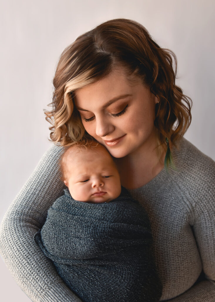 studio newborn session, mom snuggling into baby