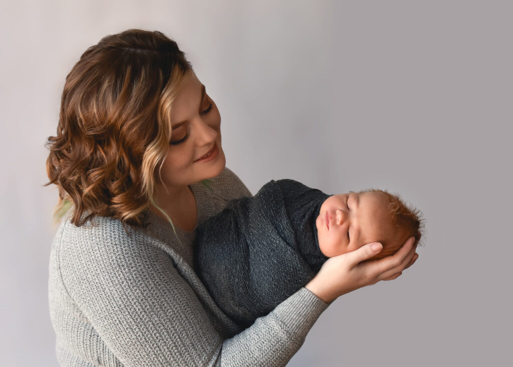 studio newborn session, mom admiring baby