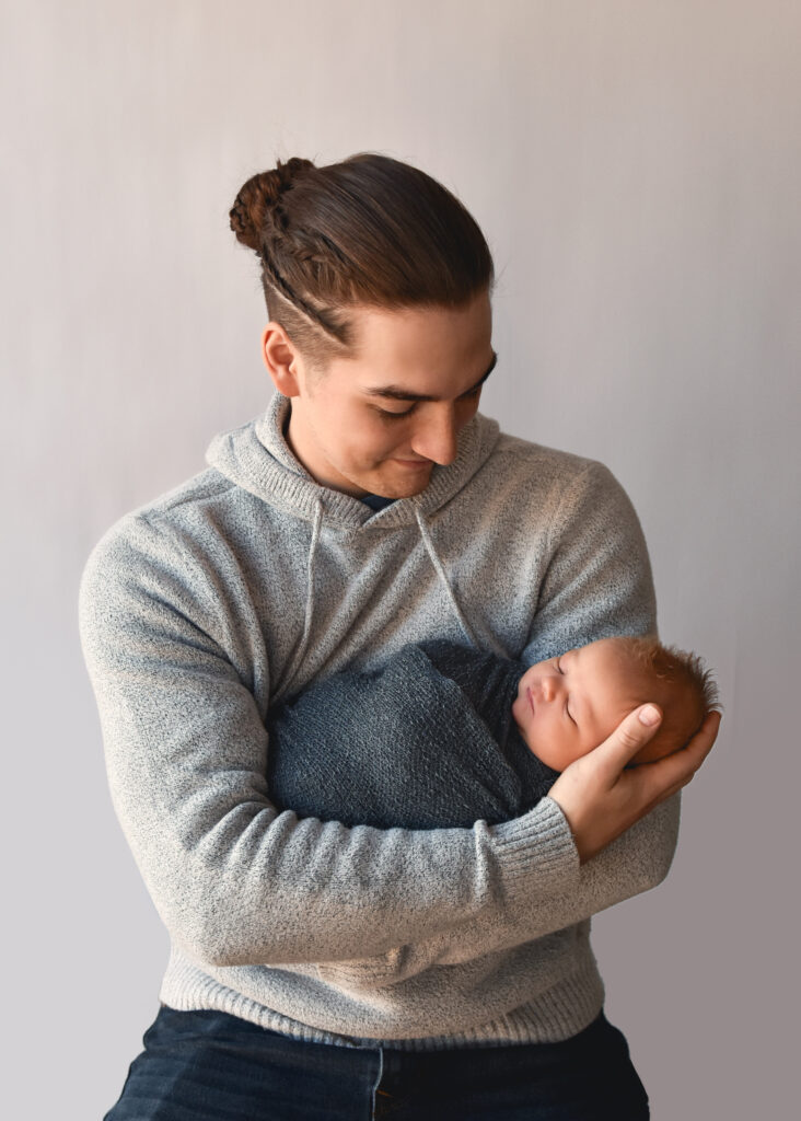 studio newborn session, dad holding baby, football hold