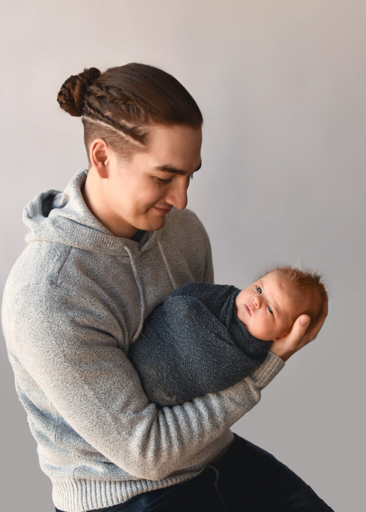 studio newborn session, dad admiring baby