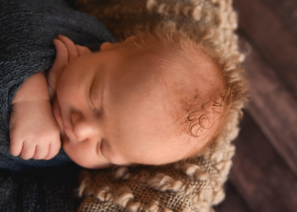 studio newborn session, closeup of baby's hair